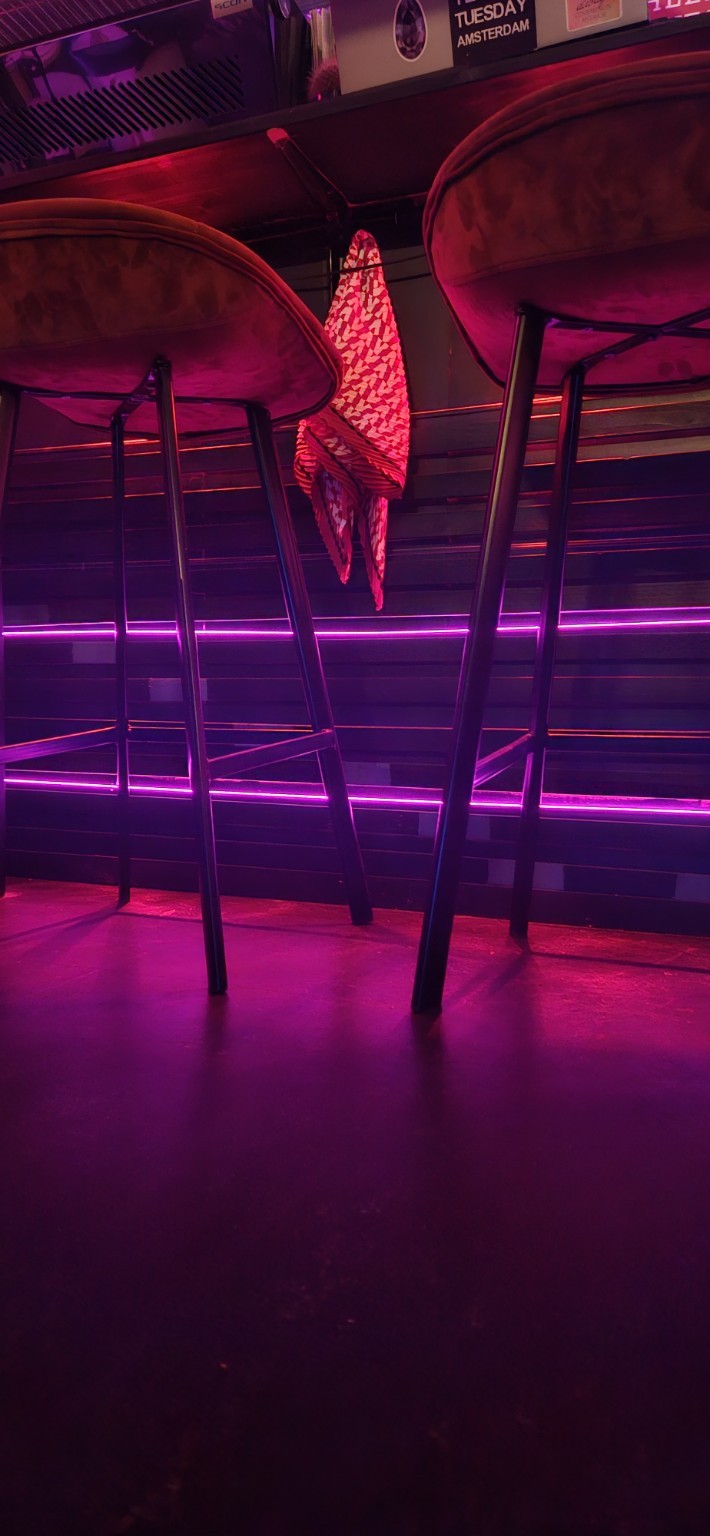 Purple-lit bar area